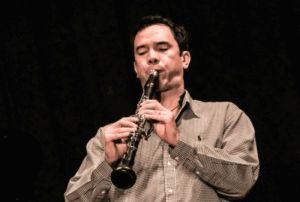 Musician blowing a horn instrument